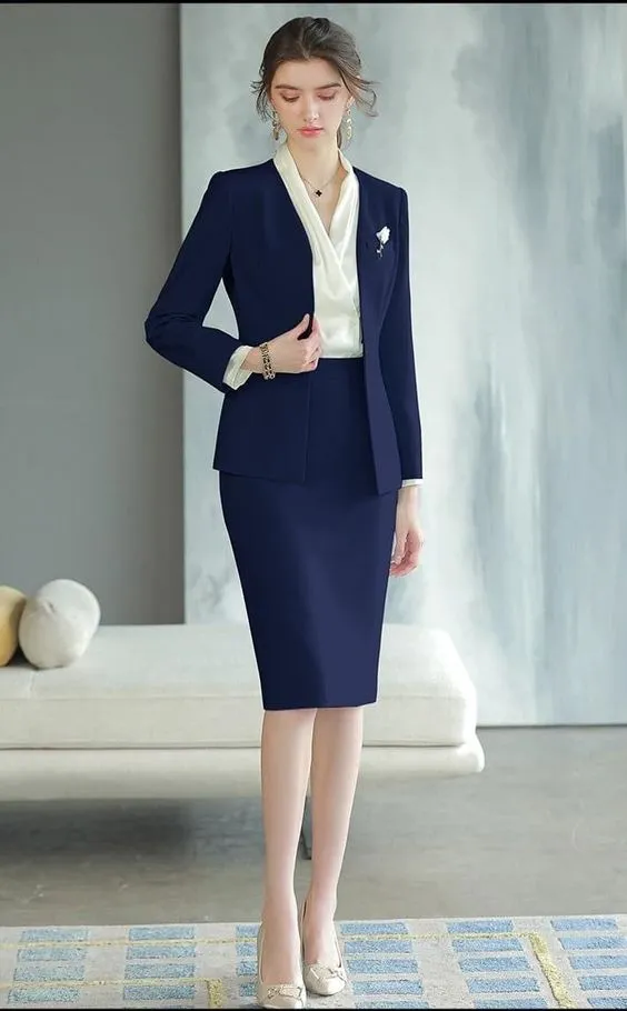 A woman in a blue suit and white shirt, representing professionalism and style in a corporate setting.