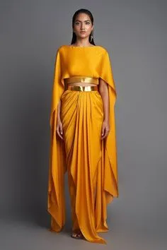 An elegant model is adorned in an orange cape and a gold belt, creating a vibrant and stylish appearance.