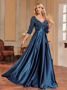 . A stunning blue evening gown elegantly drapes, showcasing its beauty and sophistication in a soft evening light.